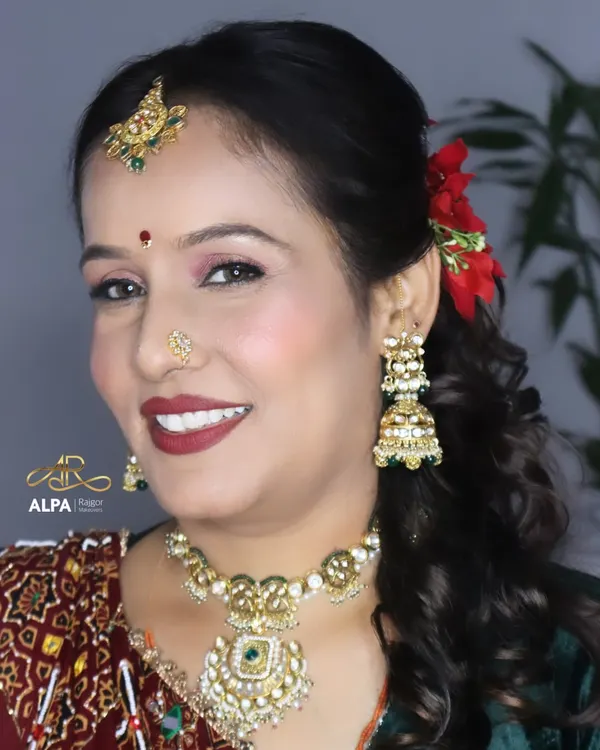 A beautiful, smiling portrait of a client over 40. The makeup is fresh and radiant, with a bold red lip that adds a touch of glamour without looking overdone.