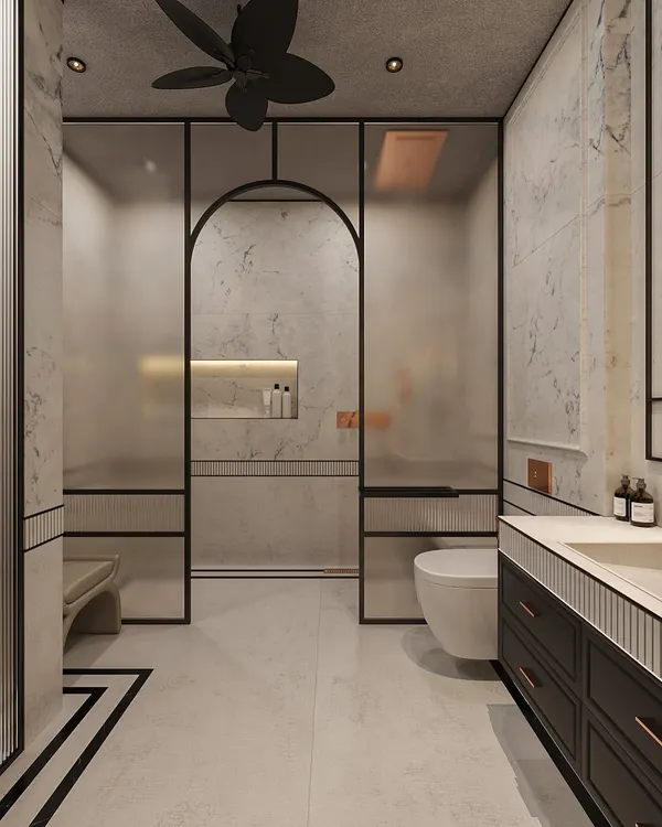 To create a cohesive design, we extended the bedroom's classical elegance into this bathroom. Marble-clad walls are framed with subtle molding, while a frosted glass archway for the shower adds a modern, graphic touch.
