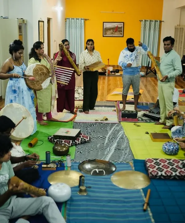 A moment from my Ojas Sound Healing Teacher Training Course. A diverse group of students, from doctors to musicians, are learning to use various instruments like the frame drum and bamboo flute.