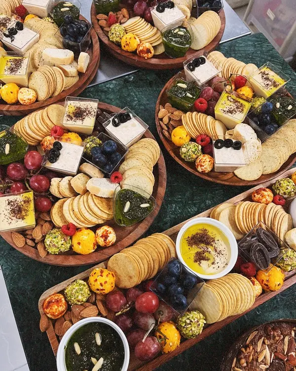A beautiful overhead view of my luxury grazing platters, ready for a celebration. I love creating these abundant spreads, filled with a variety of cheeses, dips, crackers, and fresh fruits to make any gathering feel special.