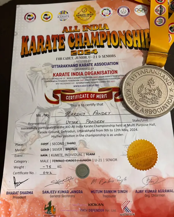 The official certificate of merit and silver medal awarded to Harshit Pandey for his performance in the senior category at the All India Karate Championship.
