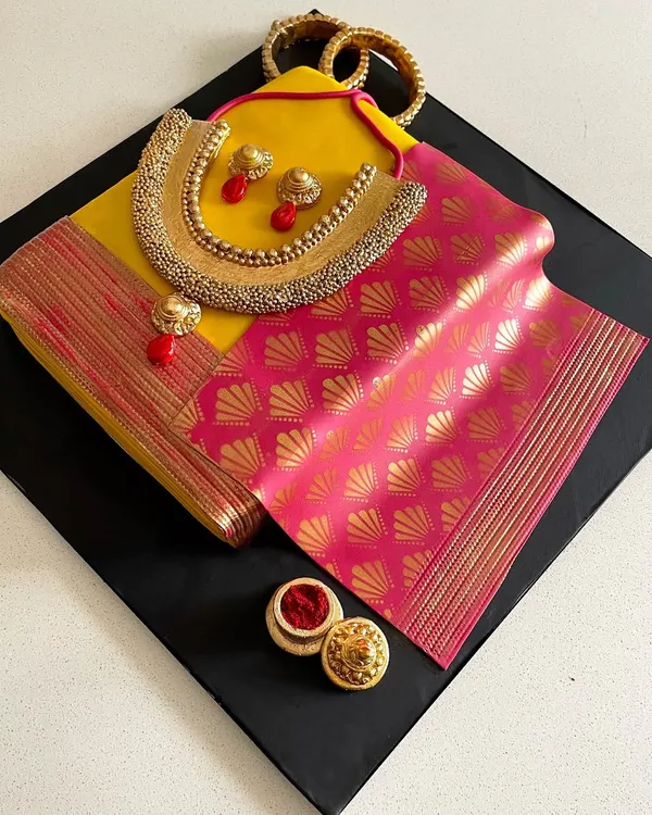 This fully edible saree cake is a tribute to our beautiful Indian heritage. I meticulously handcrafted every detail, from the delicate gold jewelry and sindoor box to the rich texture of the silk, to create a showstopper that is as much a piece of art as it is a delicious cake.