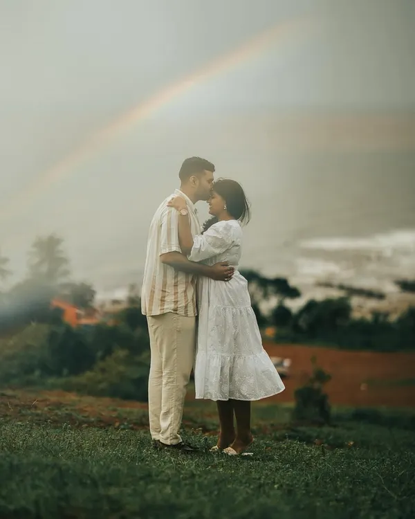 A promise under a rainbow. For me, this is what a pre-wedding shoot is all about: capturing a moment of pure magic that feels like it was made just for you. This shot from a Goa hilltop adventure is a reminder that the best moments are often unscripted.