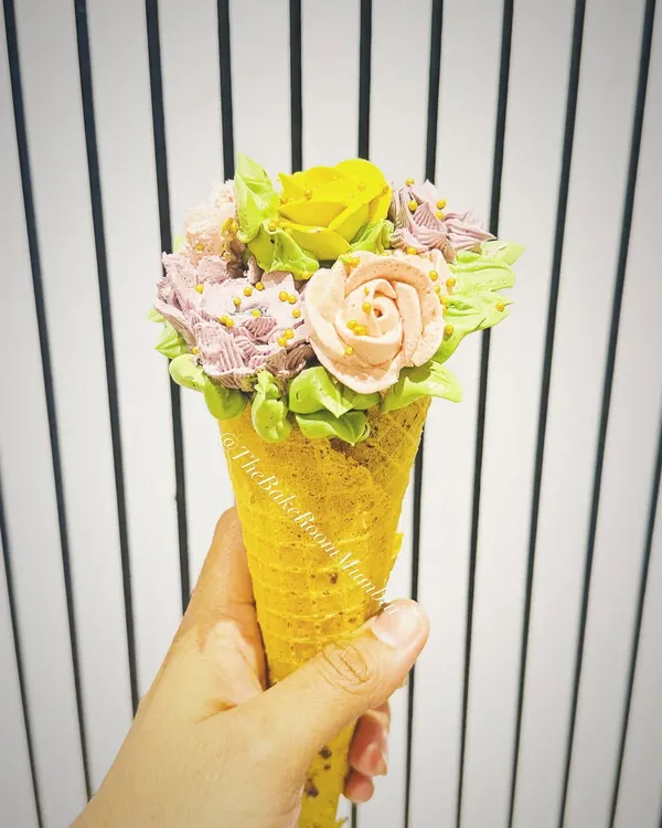 This is one of my proudest creations and a first for Mumbai: the Floral Conesicle. It's a beautiful bouquet of hand-piped, pure veg buttercream flowers on the outside, with a delicious, moist cake pop hidden inside the cone.