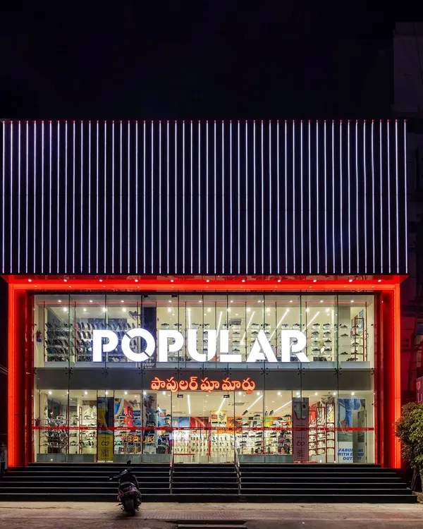 The facade of the Popular Shoe Mart in Tirupati, a project where we used a bold, red-framed glass front and a striking upper section of aluminum composite panels. A strong facade is the first chapter of the brand's story.