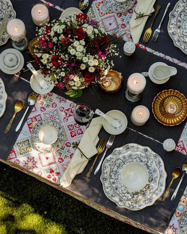 A stunning overhead shot of a fully dressed dinner table featuring Vigneto's crockery. This image captures the beauty of a complete tablescape, perfect for showcasing an entire dinnerware collection in an aspirational setting.