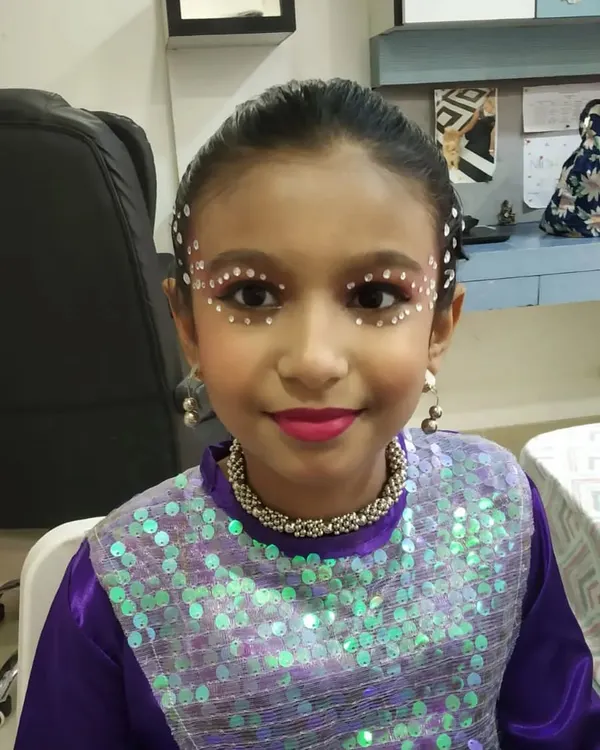 A close-up of this creative dance makeup for a young performer. I used face gems and bright lipstick to create a look that sparkles and stands out on stage.
