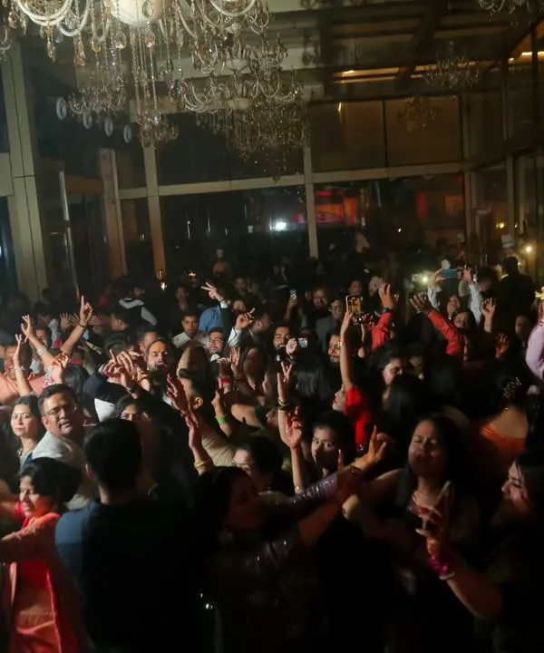 The energy of a packed dance floor at a wedding reception is electric. I love capturing these wide shots that show everyone celebrating and having an amazing time together.