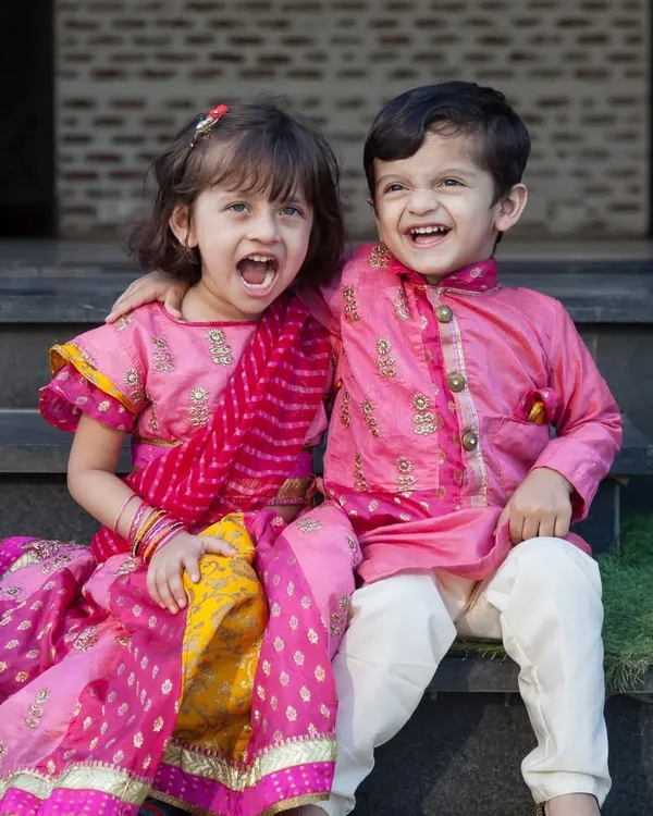 The joy and color of cultural celebrations are incredible to photograph. These siblings, dressed in beautiful traditional wear, share a laugh, creating a perfect, vibrant memory.
