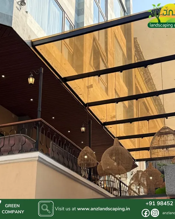 For this project, we used tinted glass for the pergola roof to reduce glare while still allowing light through. The addition of stylish wicker pendant lights adds a decorative touch to the outdoor space.