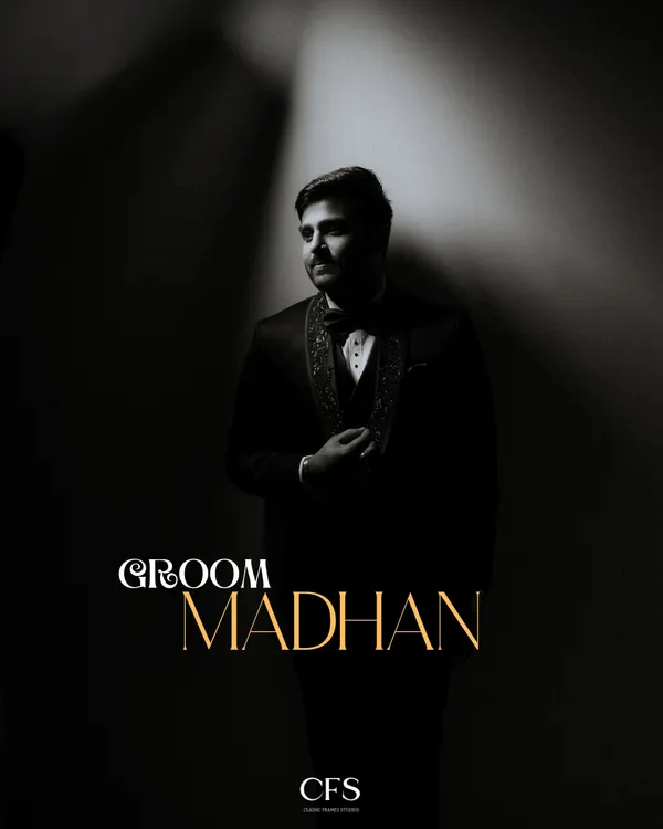 A classic, dramatic portrait of the groom in his reception tuxedo. The single light source creates a moody, cinematic effect that highlights his sharp style.