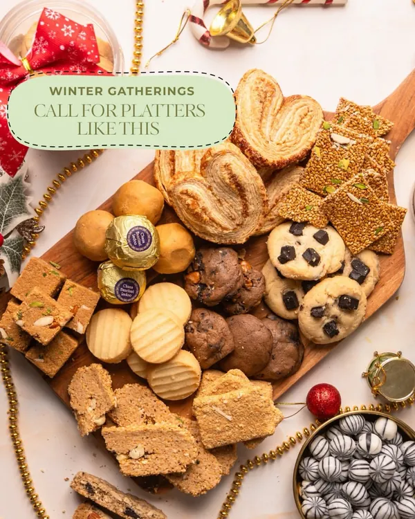 This is what winter gatherings feel like at home. A platter of my snacks in the center, conversations around it, and treats that disappear quietly. Everything is homemade, preservative free, and made for moments that don’t need an occasion.
