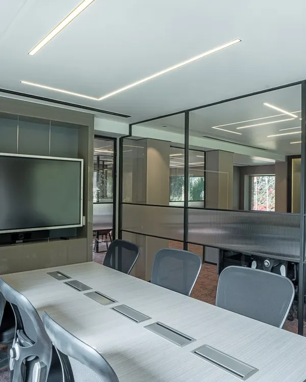 This modern conference room is designed for transparency and connection. I used glass partitions to maintain an open feel while providing acoustic privacy, and integrated linear LED lighting to create a bright, professional atmosphere conducive to collaboration.