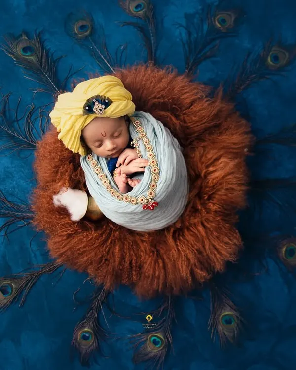 This portrait captures the divine innocence of a newborn. I used rich colors, soft textures, and an array of peacock feathers to create this unique Little Krishna setup, turning a photograph into a piece of art.