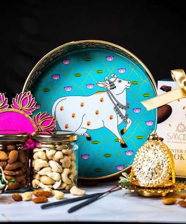 Our signature Diwali hamper, professionally shot to showcase its elegance. This festive arrangement includes a decorative tray, jars of premium dry fruits, gourmet cookies, and a traditional diya, perfect for corporate and personal gifting.