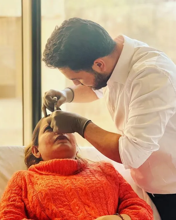 This image captures a key moment during an injectable hydration treatment. I am carefully administering a hydro-booster into the upper layers of the skin to address static lines and improve overall skin texture.