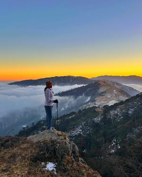 A moment of solitude and awe on the Sandakphu trail. The trek offers countless spots like this to just pause and soak in the incredible Himalayan sunrise.