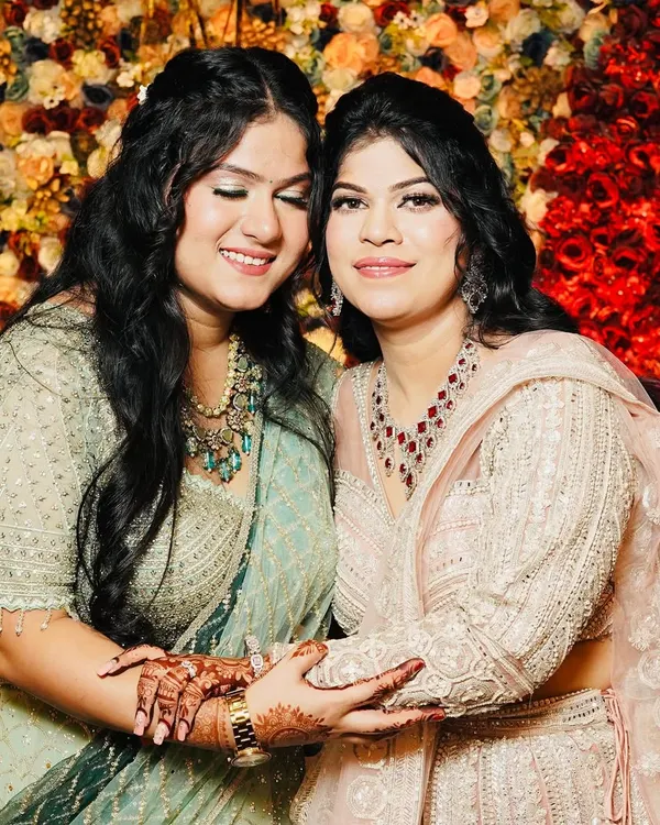 A beautiful moment between two sisters I styled for a wedding. I gave them complementary looks with soft glam makeup that highlighted their features and matched their pastel outfits.
