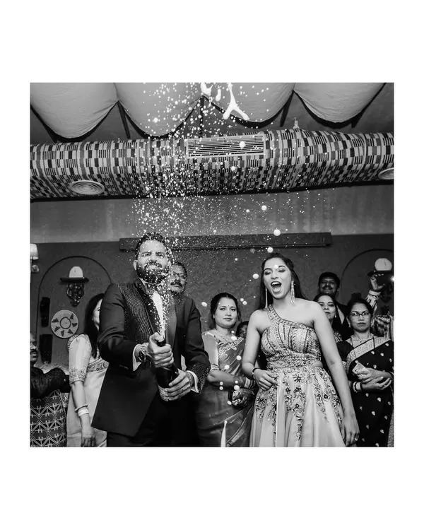 A legendary celebration begins! This black and white shot of the champagne pop is full of energy and excitement, perfectly kicking off the after-party.