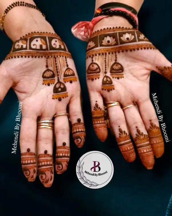 This design is so much fun, with little elephants in a band at the wrist and hanging jhumka motifs on the palm. It's a playful and trendy style that's very popular with younger guests and bridesmaids.