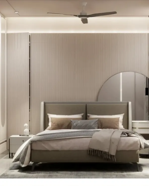 A 3D render of a master bedroom in Malad West. The design features fluted wall paneling, a large round mirror, and a neutral color palette for a calming effect.