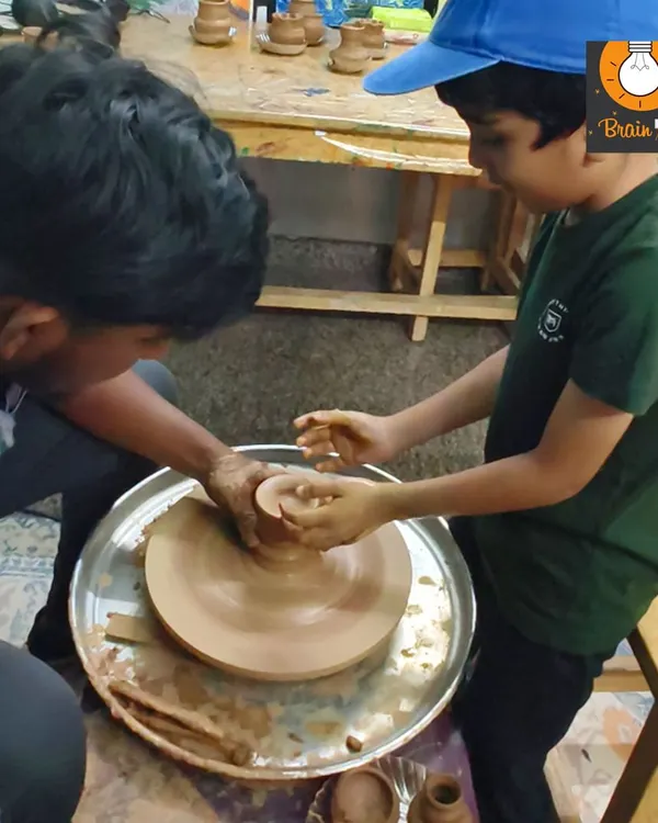 A student gets his first feel of the pottery wheel. With guidance from our instructor, he is learning how to center the clay, a fundamental skill in pottery that requires focus and calm hands.
