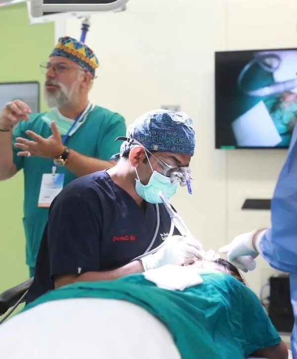 Demonstrating FUE extraction techniques during a live surgical workshop at the FUEASIA ASEAN regional event in Bangkok, Thailand.