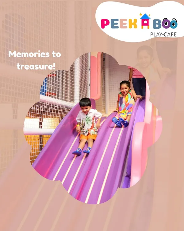 Two happy children sliding together down our vibrant purple slide. This is what it's all about: creating joyful memories and moments of pure fun in our safe and exciting indoor play area.