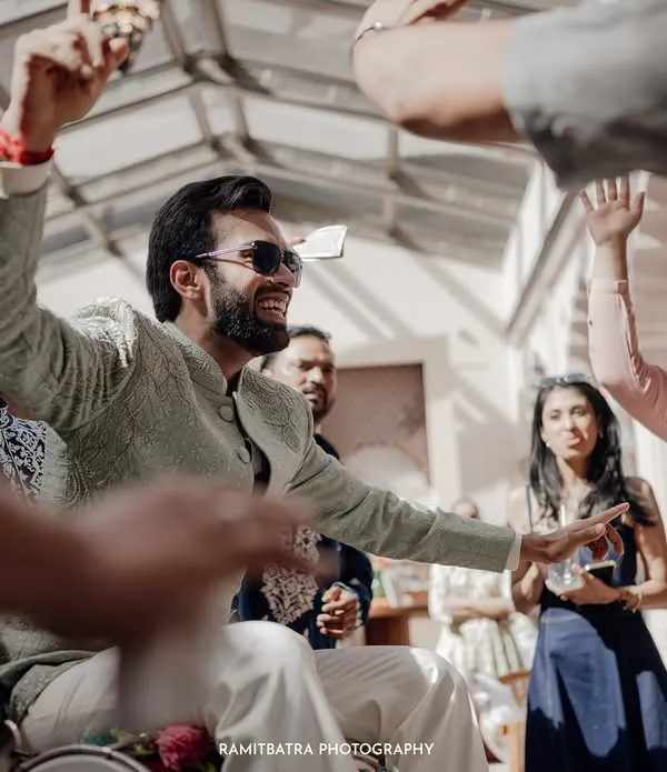 The groom makes a grand, high-energy entrance at his Sangeet, showering everyone with excitement.