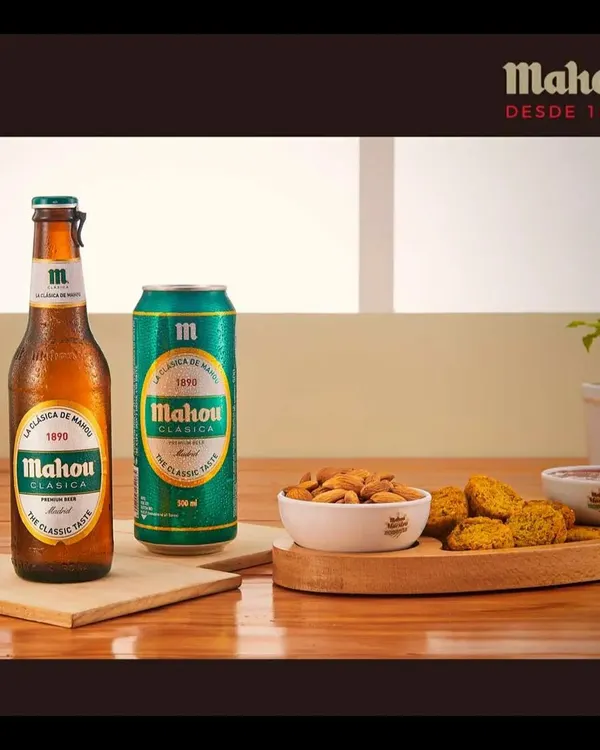 A clean product shot featuring the Mahou Clasica bottle and can. Paired with almonds and savory snacks, this image is ideal for e-commerce listings and menu photography.