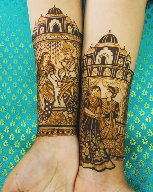 I love creating narrative designs. On the left arm, I've depicted the divine love of Radha and Krishna, and on the right, a portrait of the wedding couple, all framed by palace architecture.