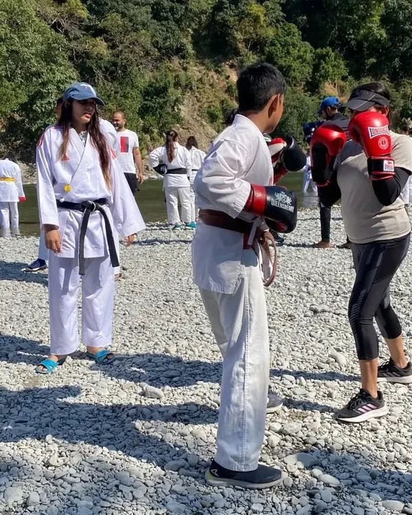 Training doesn't always happen in the gym. Here we are at an outdoor training camp, practicing boxing drills by a river, connecting with nature while honing our skills.