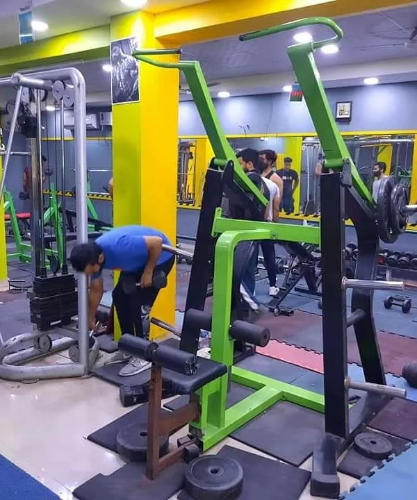 A look at our members during a busy session. You can see the lat pulldown machine in the foreground and other members using the free weights and cable machines in the background.
