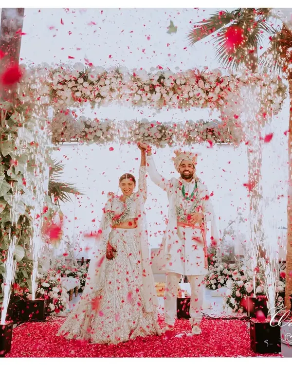 A perfect moment under a shower of petals. I focus on creating these grand, picturesque memories that you will cherish forever, ensuring your wedding day feels like a scene from a movie.
