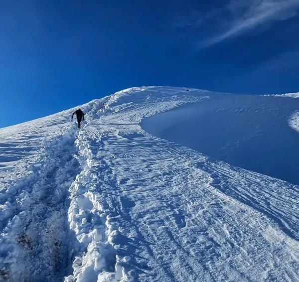 A solo trekker making their way up a snowy ridge on the Kuari Pass trek. This is what it's all about. My training ensures you have the leg strength and cardiovascular endurance to tackle long ascents in the snow, so you can lead the pack.
