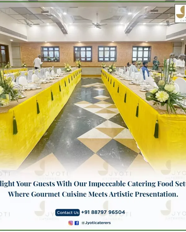 A grand sit-down dining arrangement with long tables covered in bright yellow cloths, accented with green tassels and fresh floral centerpieces.