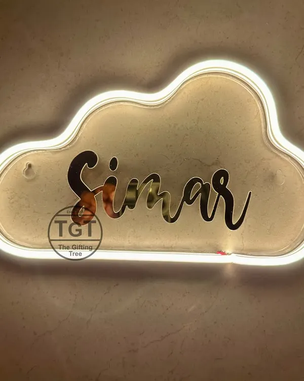This cloud-shaped neon sign features the name "Simar" in a mirrored gold finish. The warm white light creates a soft, dreamy glow.