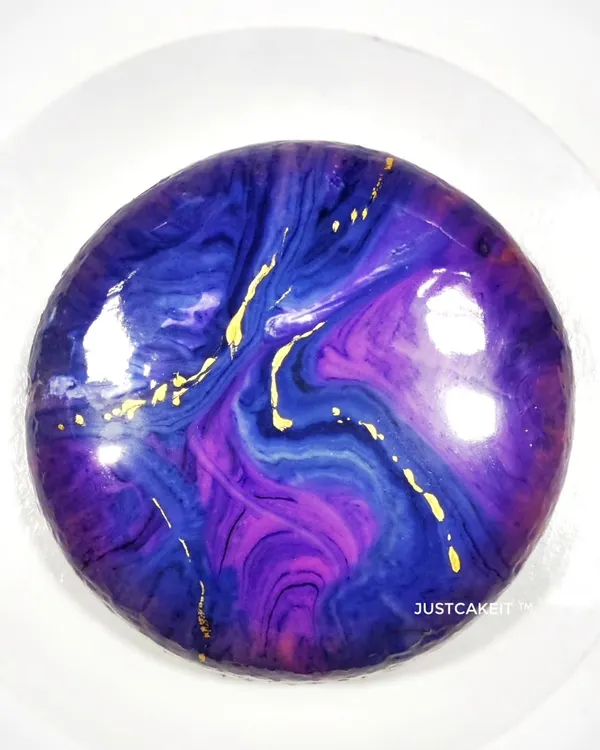 The mirror glaze on this egg-free entremet is like a galaxy. This luxurious French dessert features multiple layers of mousse and cake, offering a complex and refined flavor experience.