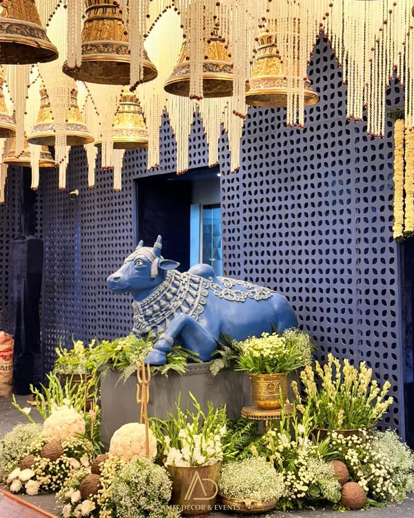 A grand installation for a Ganesh Chaturthi celebration. I used a large, custom-made Nandi statue as a centerpiece, surrounded by lush florals and set against a backdrop of hanging temple bells and pearl strings.