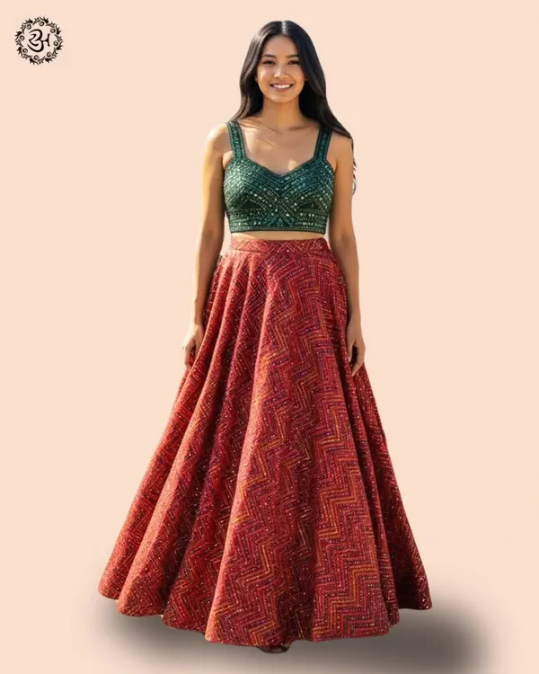 Celebrate in style with this stunning red lehenga, paired with a contrasting green sequined blouse. It's a perfect ensemble for a Dandiya night or any festive occasion, blending tradition with vibrant energy.