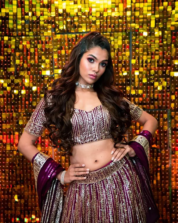 A flawless mix of elegance and glamour. This look, with its bold eye makeup and radiant skin, is perfect for a Sangeet or reception, set against a glittering backdrop.