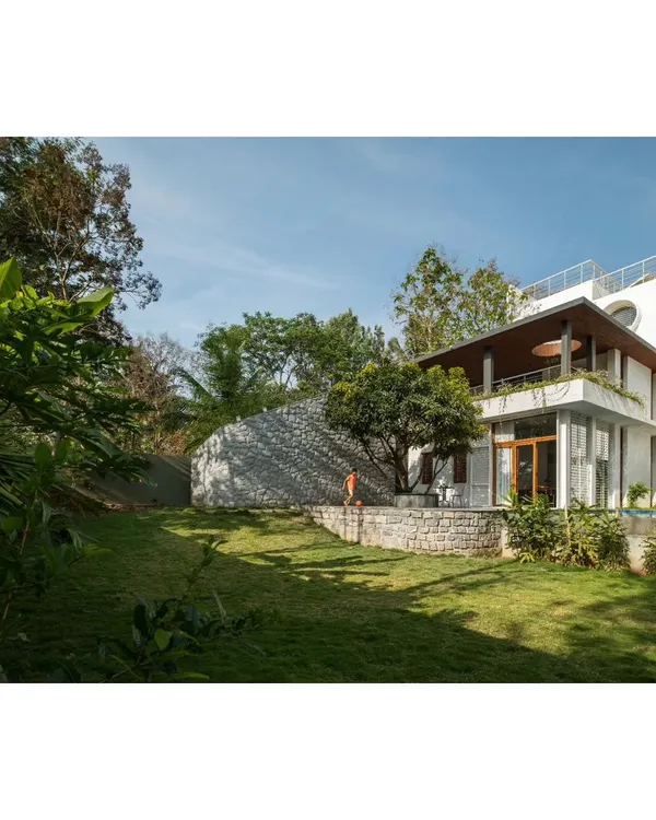 The Siri residence was designed as a seamless extension of its natural landscape. The structure respects and celebrates the existing trees, with the garden and home flowing into one another.