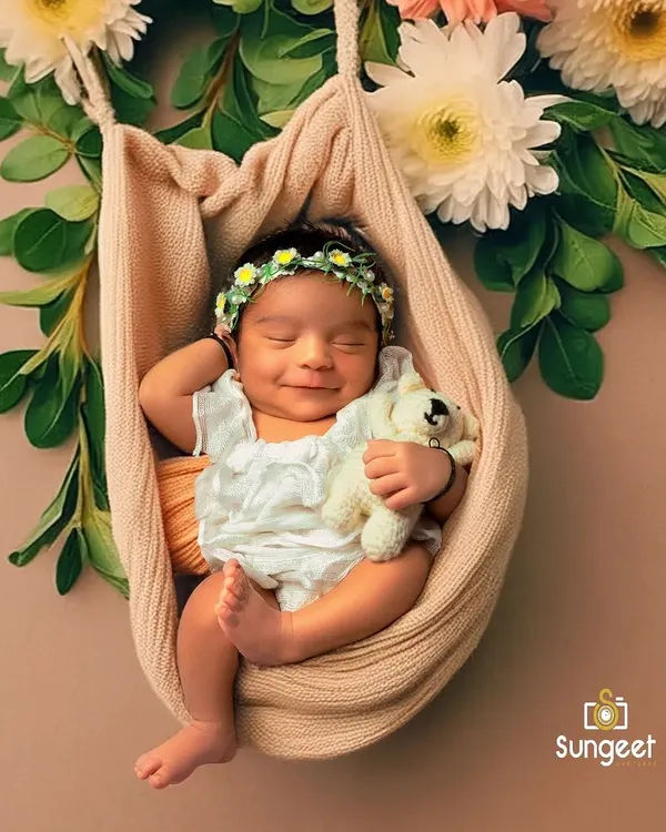 This is the magic we live to capture. A serene smile from a precious newborn, cradled safely and surrounded by flowers. These are the fleeting moments of pure bliss we freeze in time for your family.