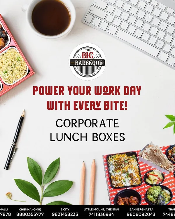 A bird's-eye view of our corporate lunch box, laid out on a work desk. It shows the variety packed inside, including biryani, starters, and sides, making for a perfect and productive workday meal.