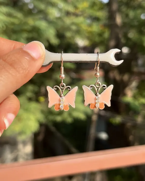 These cute peach butterfly earrings are perfect for adding a whimsical touch to your day. They are part of my collection of earrings under 100/-.