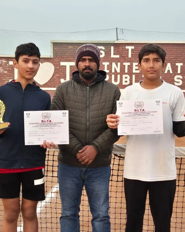 A triple crown for Anay Pandey at the CS7 Tournament in Sonipat. He stands with his coach after winning the U-14 Singles, U-16 Singles, and U-16 Doubles titles.