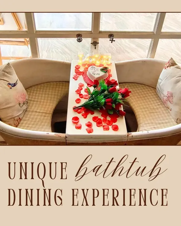 My unique bathtub dining experience is something you won't find anywhere else. This setup, decorated with roses and a custom cake, shows how I can prepare it for a romantic celebration.