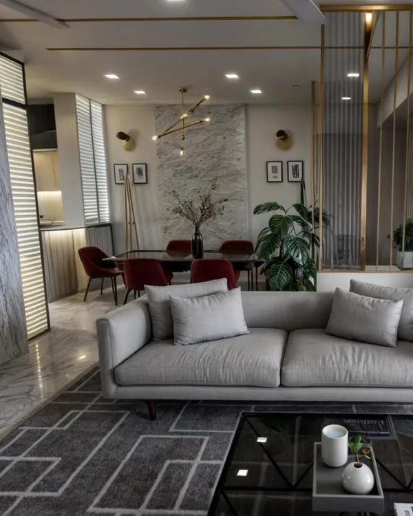 This is a glimpse into a lavish living and dining area we designed in Goregaon. The space features Italian marble flooring, a custom geometric area rug, and a statement chandelier, all working together to create an atmosphere of sophisticated luxury and refined living.