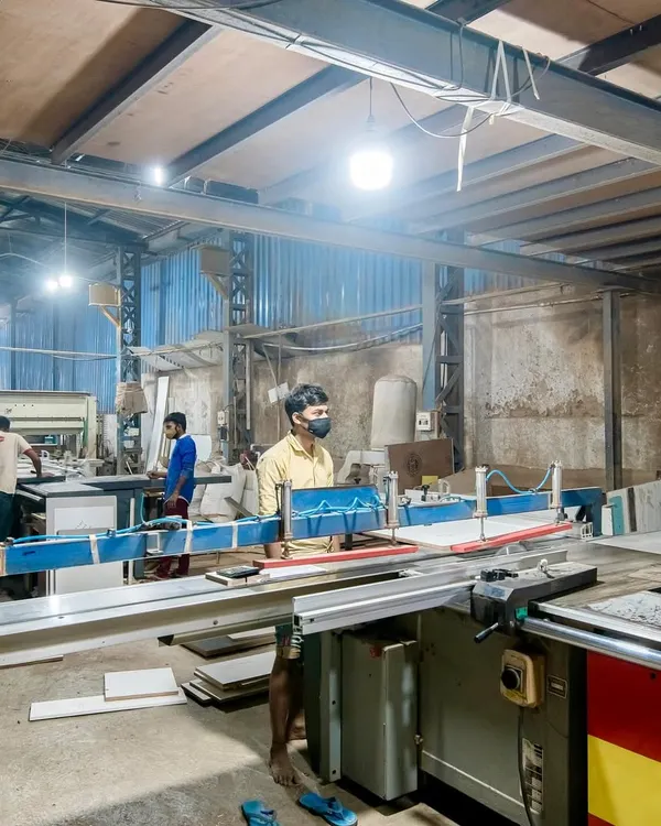 An overview of our factory floor, where raw materials are transformed into finished modular components. Our skilled team works with state-of-the-art equipment to produce everything from desks to storage cabinets.