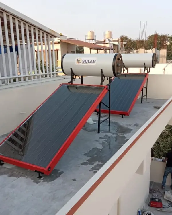 A recent rooftop installation featuring two of our FPC solar water heating systems. The client chose a custom red frame for the collector panels to match their home's exterior, showcasing one of the aesthetic options we provide.